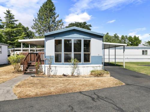 A mobile home for sale in a park.