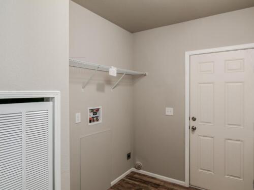 A room with a door and a fan in it.