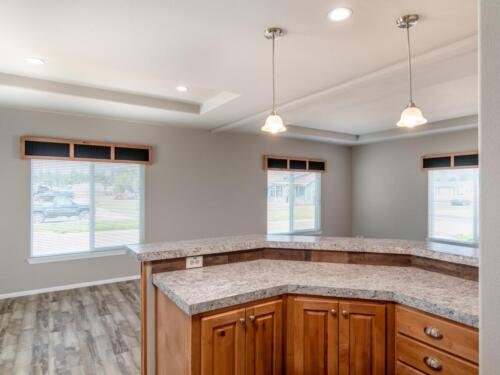 A kitchen with granite counter tops and hardwood floors.